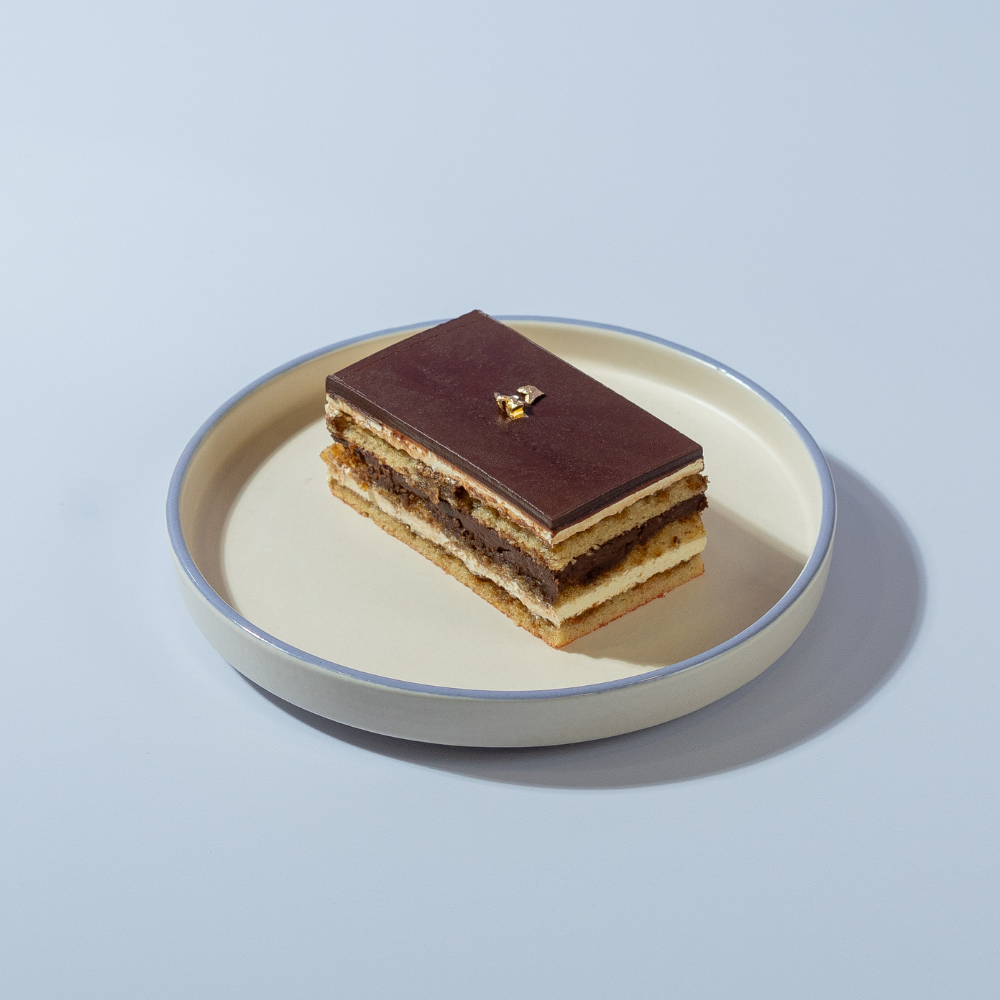 Opera Pastry Le Fou Delights French opera pastry slice with layers of almond sponge, chocolate ganache, and coffee buttercream