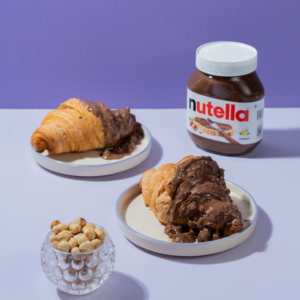Rocher Glazed Croissant in Vadodara filled with Nutella and topped with Ferrero Rocher-inspired glaze by Le Fou Delight