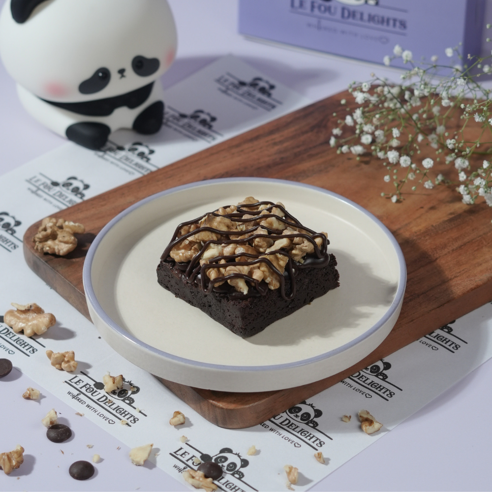 Chocolate Walnut Brownie (3) Slice of rich chocolate walnut brownie showing crackly crust and crunchy nuts