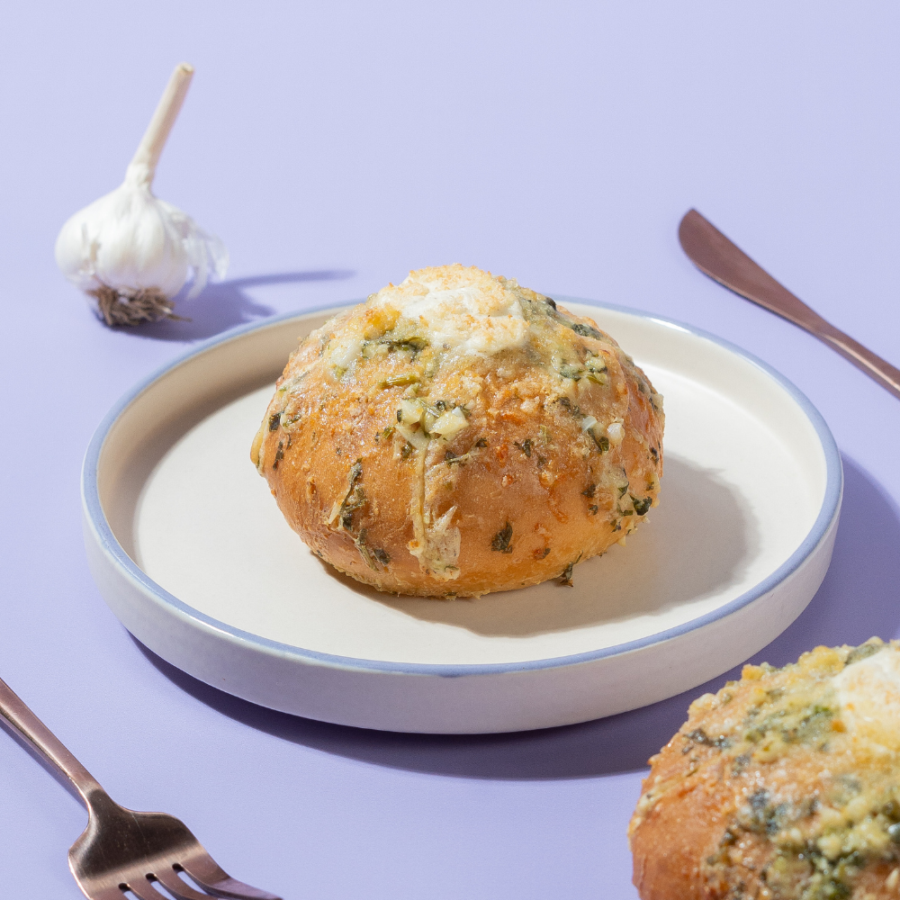 Golden toasted Korean garlic bun stuffed with creamy garlic cream cheese fillingGolden toasted Korean garlic bun stuffed with creamy garlic cream cheese filling