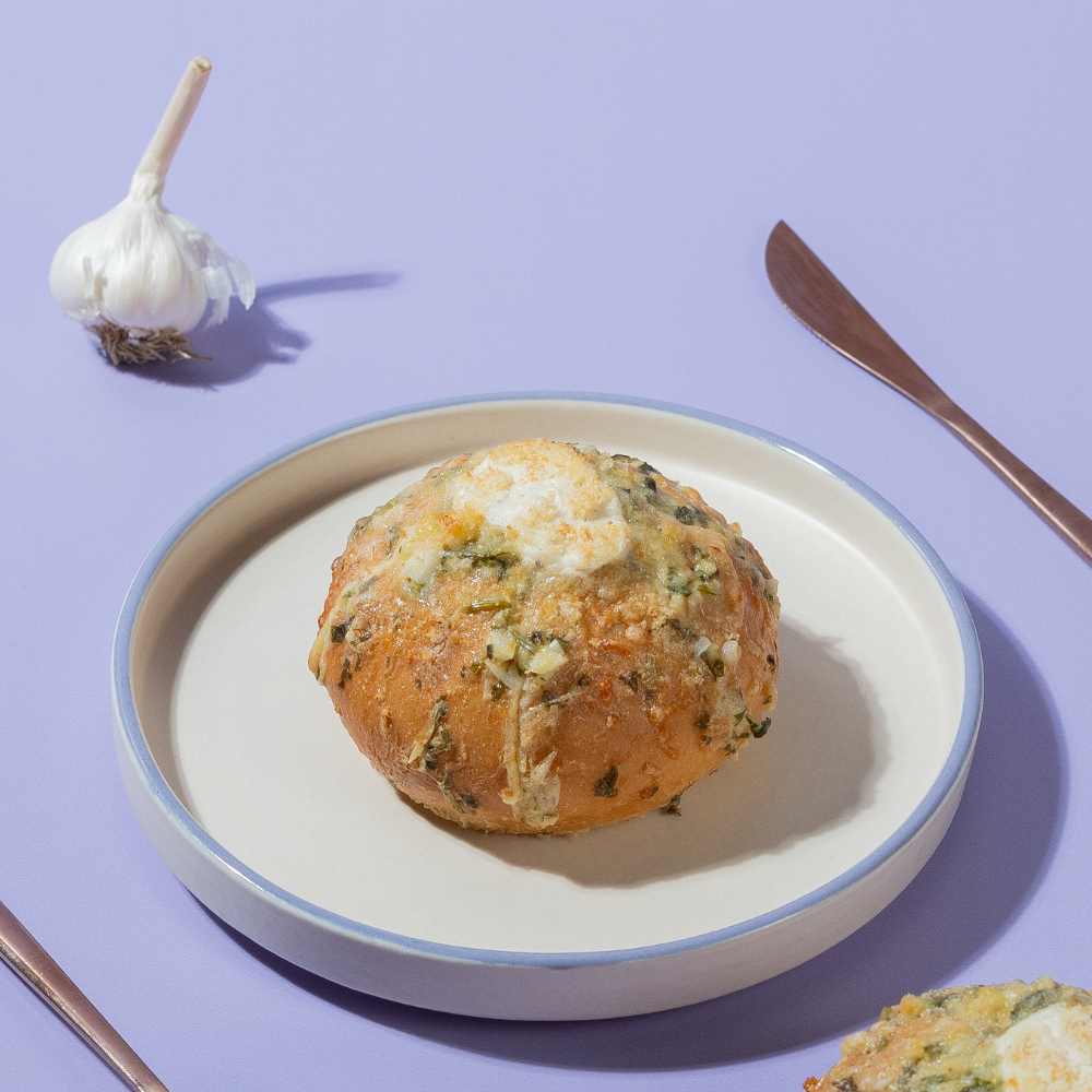Golden toasted Korean garlic bun stuffed with creamy garlic cream cheese fillingGolden toasted Korean garlic bun stuffed with creamy garlic cream cheese filling