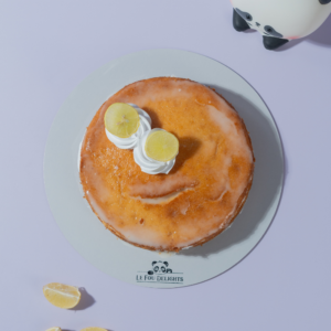 Lemon Drizzle Cake in Vadodara with soft lemon sponge, signature lemon drizzle, and Chantilly cream by Le Fou Delight