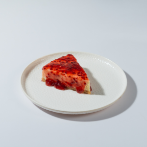 Raspberry New York baked cheesecake topped with tangy compote by Le Fou Delight Vadodara