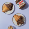 Rocher Glazed Croissant in Vadodara filled with Nutella and topped with Ferrero Rocher-inspired glaze by Le Fou Delight