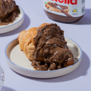 Rocher Glazed Croissant in Vadodara filled with Nutella and topped with Ferrero Rocher-inspired glaze by Le Fou Delight