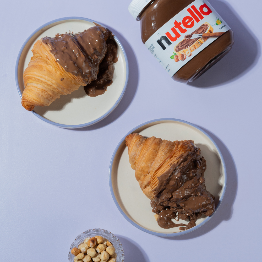 Rocher Glazed Croissant in Vadodara filled with Nutella and topped with Ferrero Rocher-inspired glaze by Le Fou Delight