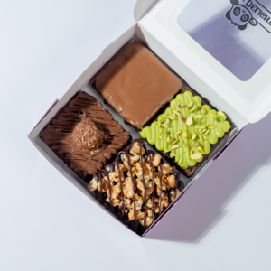 Pack of 4 brownies in Vadodara by Le Fou Delights with chocolate, caramel, pistachio, and walnut toppings on rich fudgy brownies.