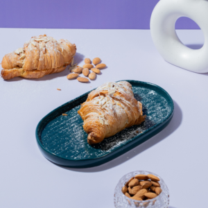 Golden toasted almond croissant sliced open to reveal smooth frangipane filling