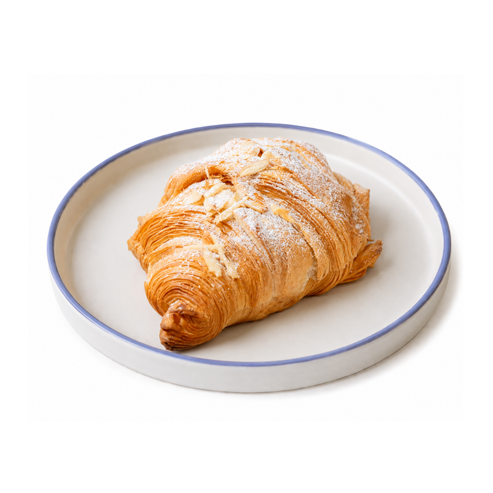 Golden toasted almond croissant sliced open to reveal smooth frangipane filling