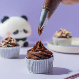 Almond Milk Chocolate Cupcake in Vadodara topped with milk chocolate ganache, roasted almonds, and filled with almond praline by Le Fou Delight