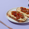 Fresh Balsamic & Roasted Tomato Hummus Toast on artisan sourdough at Le Fou Delight Vadodara