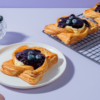 Golden baked blueberry custard Danish pastry topped with fresh blueberry filling