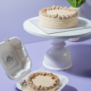 Eggless coffee walnut cake topped with roasted walnuts by Le Fou Delight Vadodara