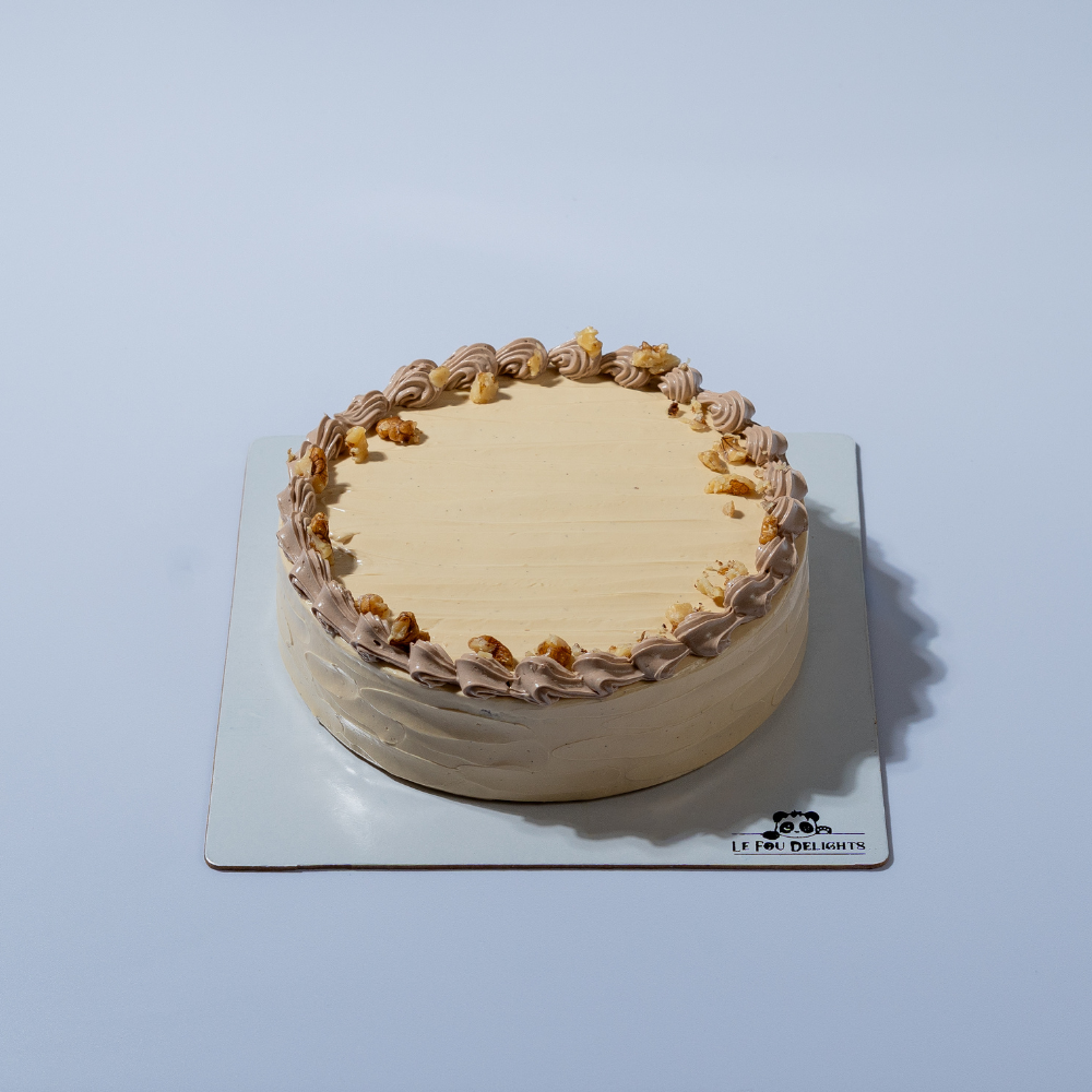 Eggless coffee walnut cake topped with roasted walnuts by Le Fou Delight Vadodara