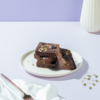 Fudgy gluten-free ragi chocolate brownie slice topped with healthy seeds