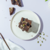 Fudgy gluten-free ragi chocolate brownie slice topped with healthy seeds