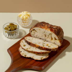 Sliced jalapeño cheddar cheese sourdough bread showing melted cheddar pockets and fresh jalapeño slices