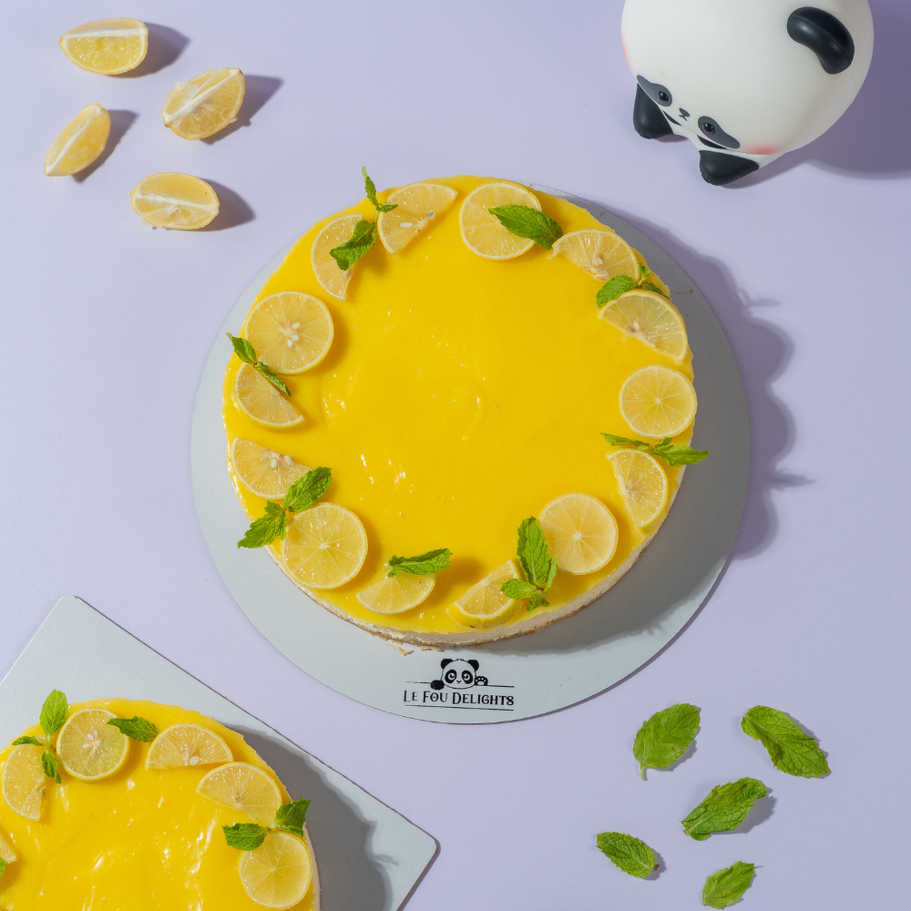 Fresh Lemon Cheesecake in Vadodara by Le Fou Delight with creamy New York-style filling, buttery biscuit crust, and fresh lemon topping.