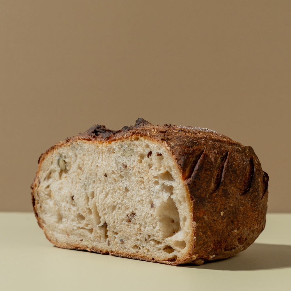 Fresh Multigrain Sourdough loaf with wholesome grains and seeds by Le Fou Delight in Vadodara