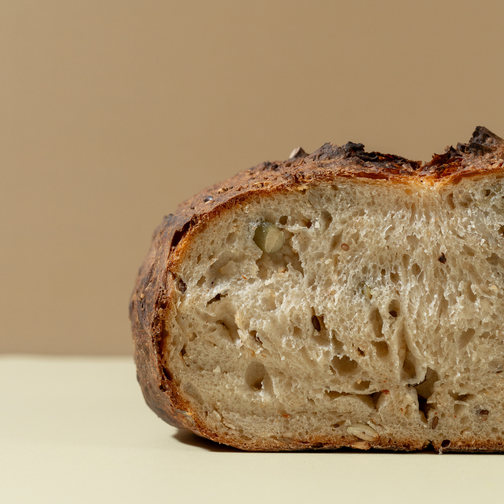 Fresh Multigrain Sourdough loaf with wholesome grains and seeds by Le Fou Delight in Vadodara