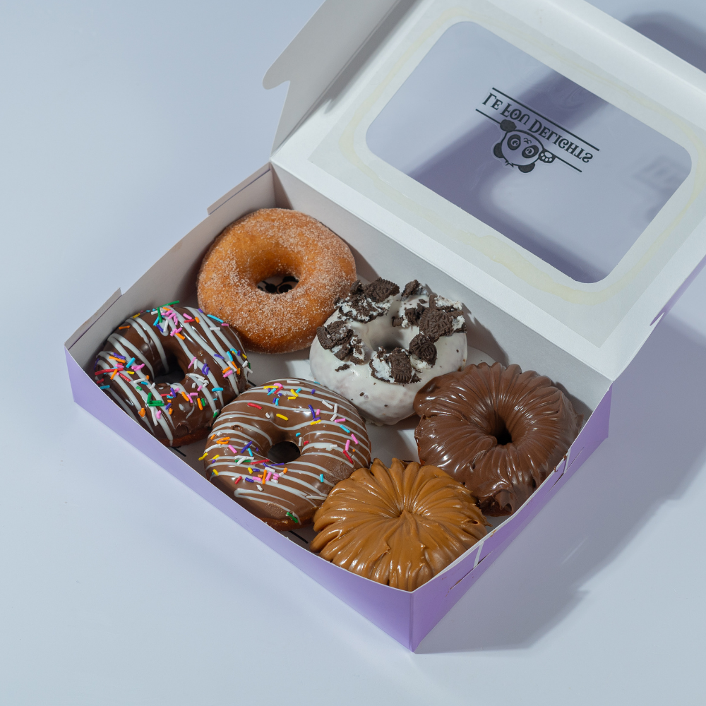 Pack of 6 assorted donuts with chocolate and caramel toppings from Le Fou Delight