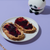 Toasted artisan sourdough slice loaded with peanut butter and rich berry fruit jam