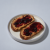 Toasted artisan sourdough slice loaded with peanut butter and rich berry fruit jam