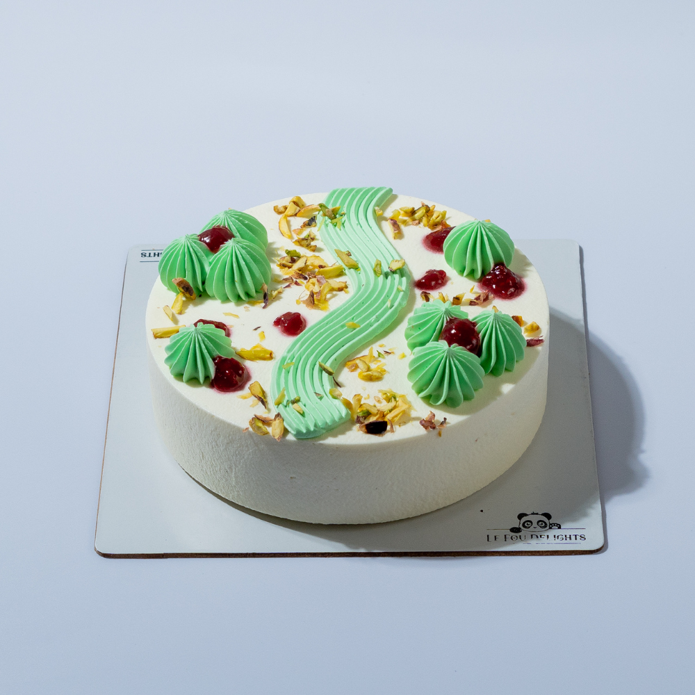 Eggless pistachio and raspberry cake with pistachio ganache by Le Fou Delight Vadodara