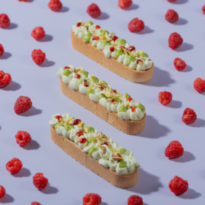Raspberry Pistachio Tart slice with visible raspberry compote, Le Fou Delight