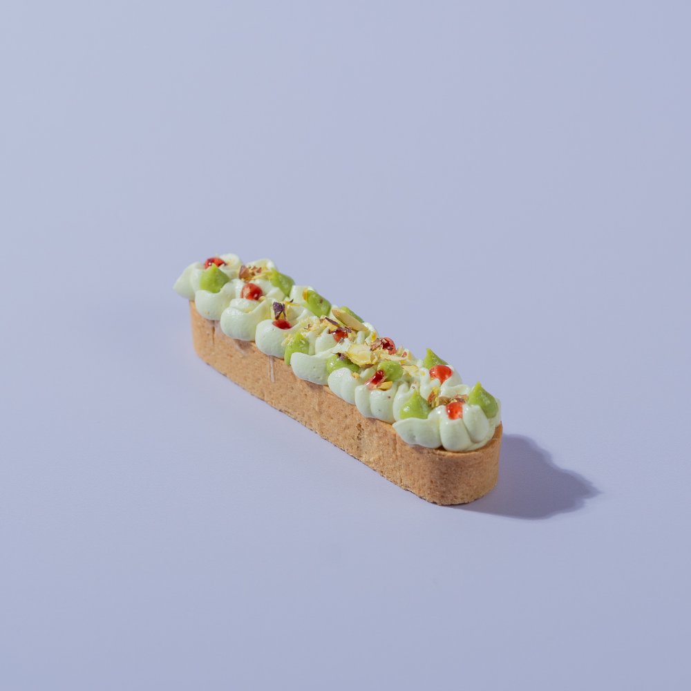 Raspberry Pistachio Tart slice with visible raspberry compote, Le Fou Delight