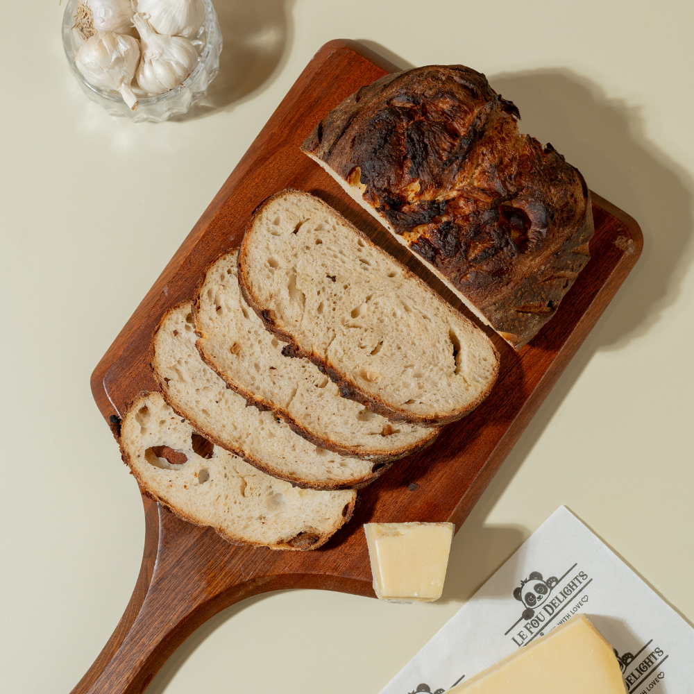Freshly prepared savory garlic parmesan sourdough bread ready for bakery delivery in Vadodara