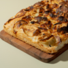 Freshly baked Italian roasted garlic potato focaccia bread drizzled with olive oil by Le Fou Delight Vadodara