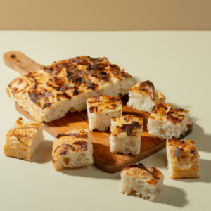 Freshly baked Italian roasted garlic potato focaccia bread drizzled with olive oil by Le Fou Delight Vadodara