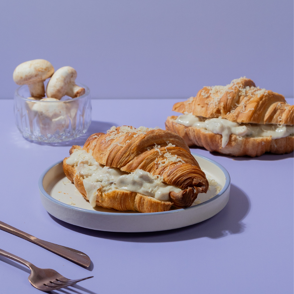 Flaky French savory truffle mushroom croissant filled with creamy mushrooms by Le Fou Delight Vadodara