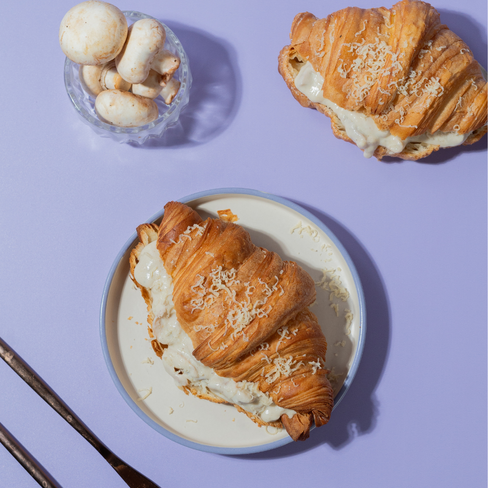 Flaky French savory truffle mushroom croissant filled with creamy mushrooms by Le Fou Delight Vadodara
