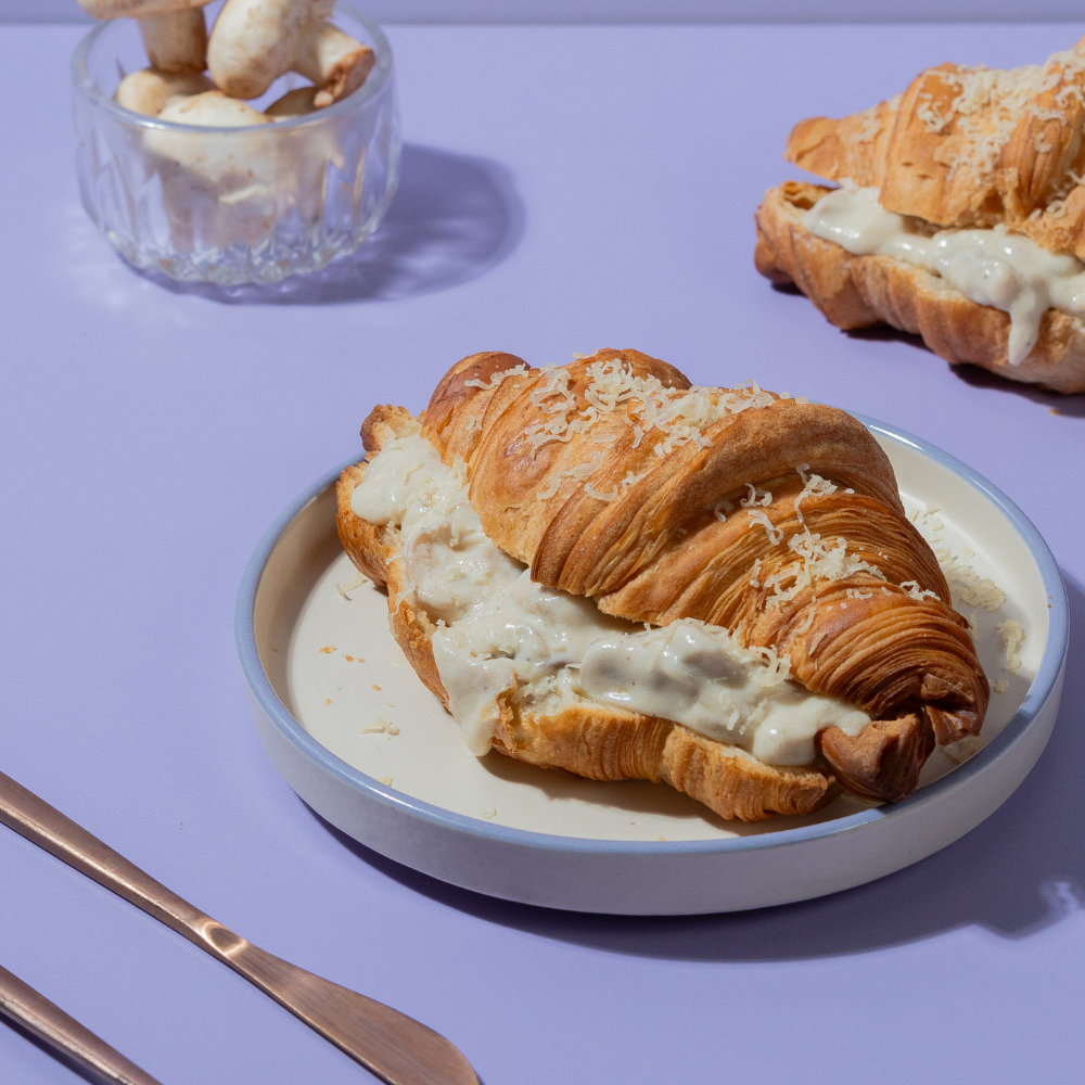 Flaky French savory truffle mushroom croissant filled with creamy mushrooms by Le Fou Delight Vadodara