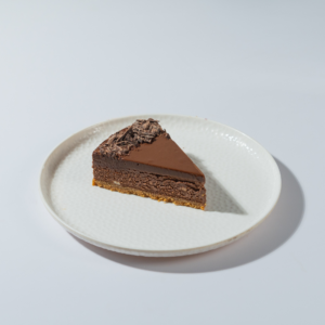 Slice of ultimate chocolate cheesecake showing velvety texture and chocolate biscuit base